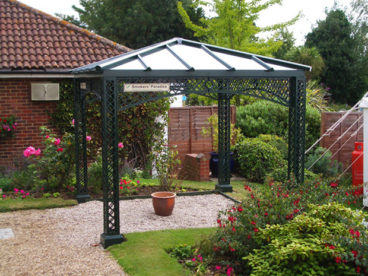 <p>A square Smoking Shelter in the grounds of a hotel in Essex.</p>
