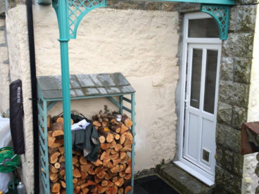 <p>This colourful porch adds a splash of colour on a dull day! A useful place to store logs, as well as a stylish way to keep dry whilst going in or out of your home. </p>

