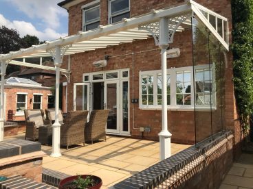 <p>Completed in summer 2018, this verandah has our toughened glass screens to one side. Finished in cream, using our V8 columns with lattice quarter arches. </p>
