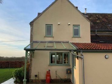 <p>Colour matched to our customer's door and windows, This simple lean-to was installed in January 2021 in Cornwall. Royale column with circles quarter arches.</p>
