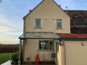 <p>Colour matched to our customer's door and windows, this simple lean-to was installed in Cornwall. Created using our ever-popular Royale column with circles quarter arches.</p>
