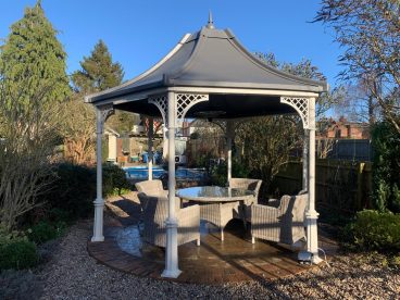 <p>This impressive hexagonal gazebo was installed near Market Harborough in 2021. The bespoke faux-lead roof is complimented by our Royale columns and lattice quarter arches, finished in cream. </p>
